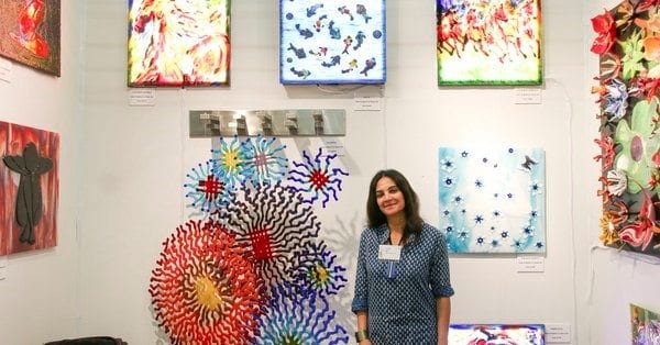 Hasna Sal surrounded by her artwork